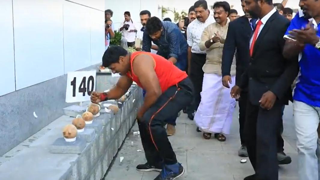 Most coconuts smashed with one hand in one minute header
