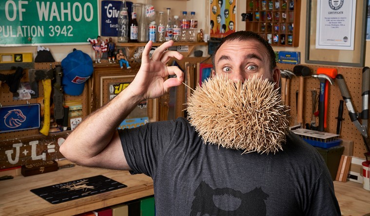 man with multiple toothpicks in mouth