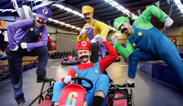 4 men dressed as characters from mario kart