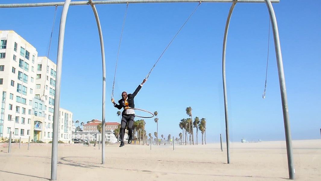 Longest distance swinging on rings while hula hooping