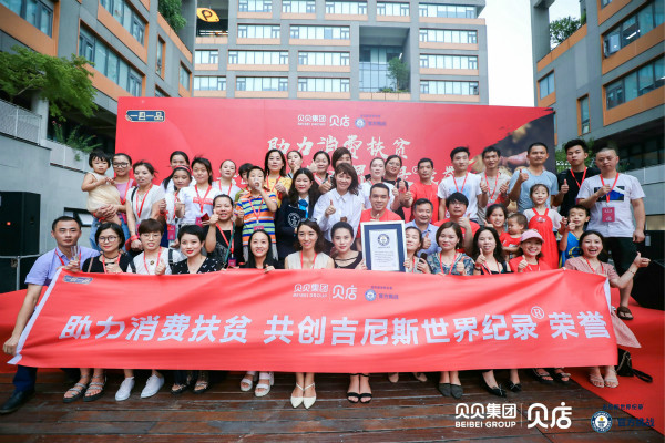 record breakers behind a red banner and one man holding gwr certificate