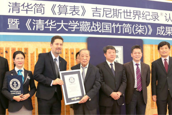 men in suits posing next to gwr certificate 