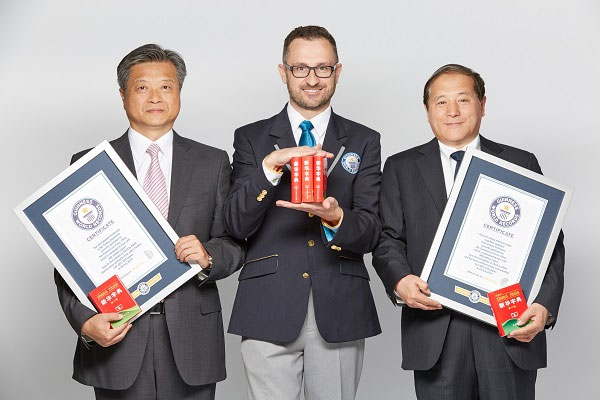 two men holding gwr cvertificates next to an adjudicator