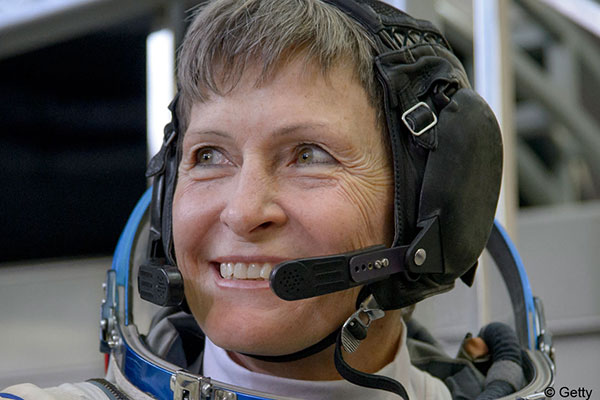 peggy whitson smiling whiel wearing headset
