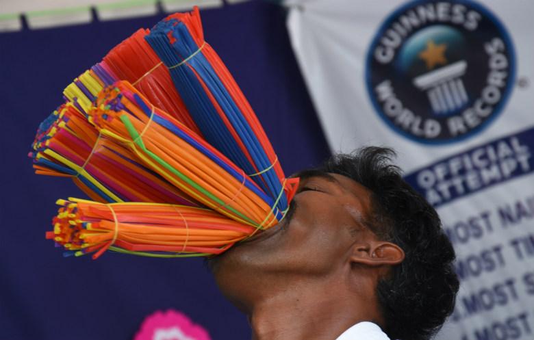Most straws stuffed in the mouth (hands off)